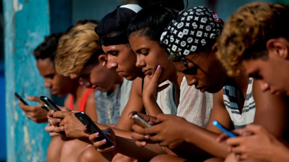 People with cell phones in Cuba, 2019