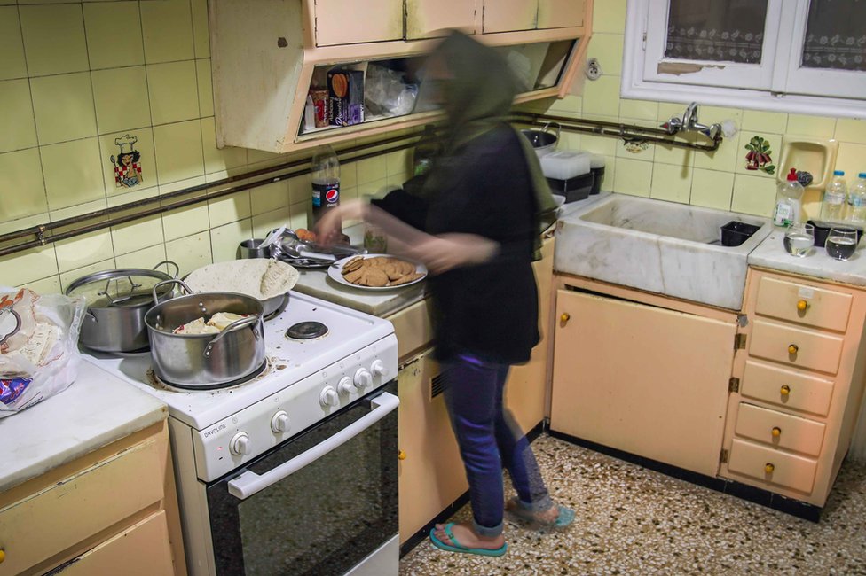 Sana in her Greek accommodation. Every day the authorities bring cooked food for the families to reheat and share.