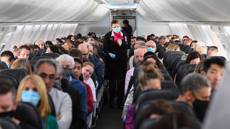 A plane carrying mask-wearing passengers between Sydney and Adelaide in 2020