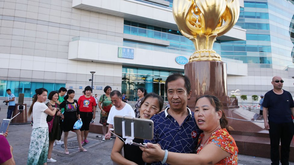 Mainland tourists visit the Golden Bauhinia Square in Wan Chai, 2017