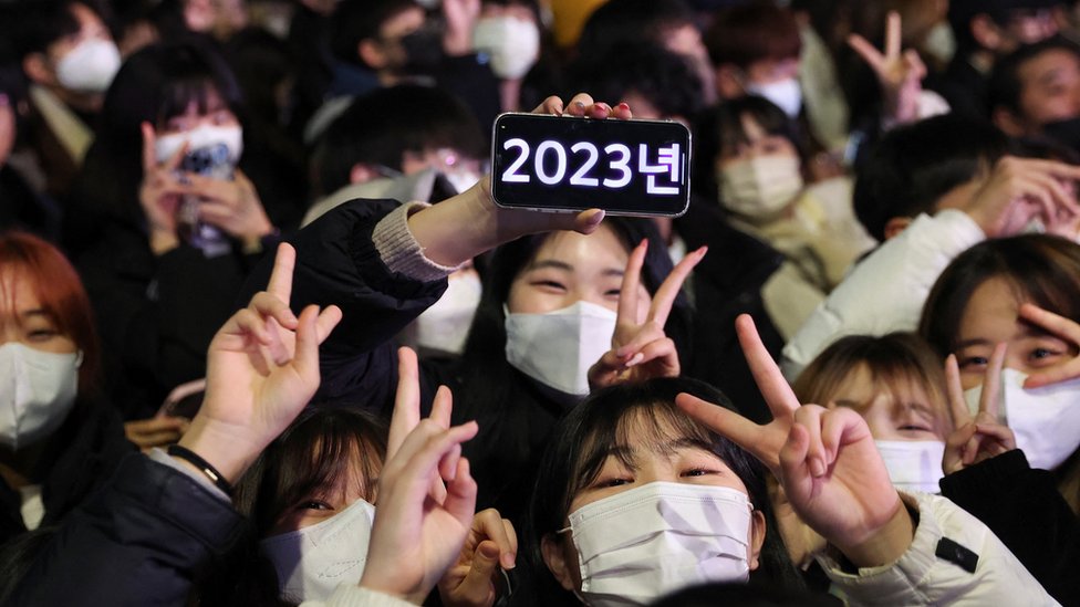 People gather to celebrate the clocks turning midnight in Seoul, South Korea