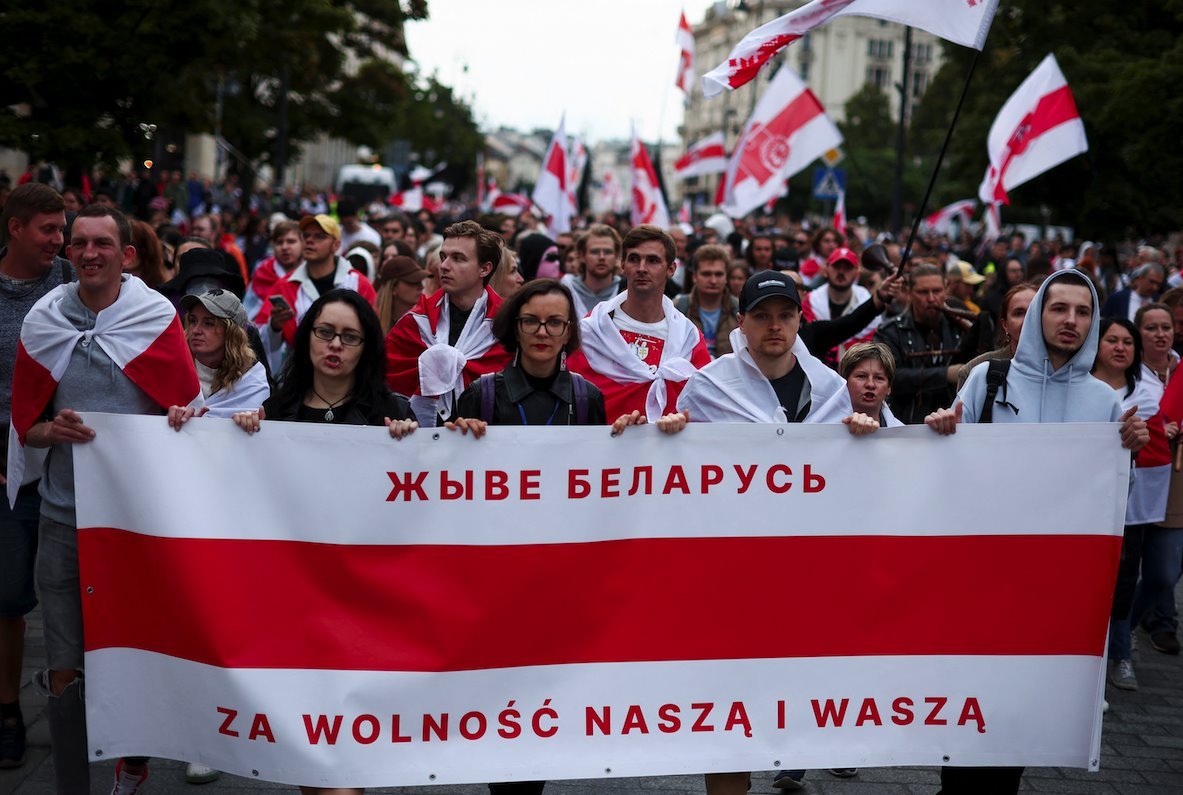 People carrying historical white-red-white flags of Belarus take part in Belarusians' march through Warsaw, on the third anniversary of the 2020 presidential election which was followed by mass protests over alleged electoral fraud, in Warsaw, Poland, August 9, 2023.