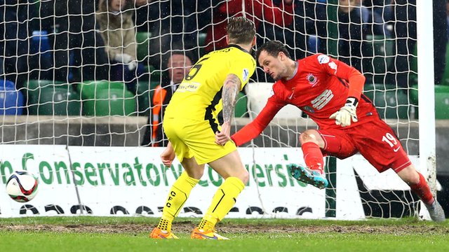 Linfield goalkeeper Ross Glendinning is beaten by Jay Donnelly's strike