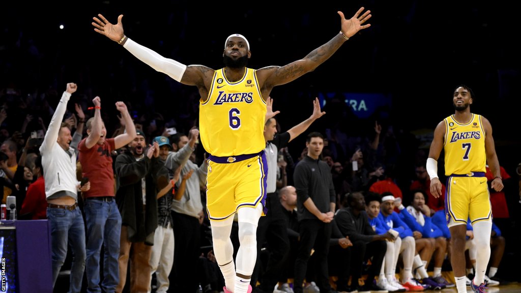 Lebron James with both arms in the air after breaking the record