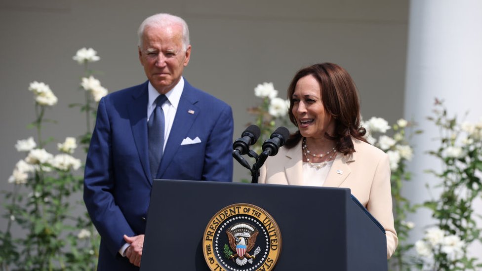 كامالا هاريس ويظهر خلفها جو بايدن