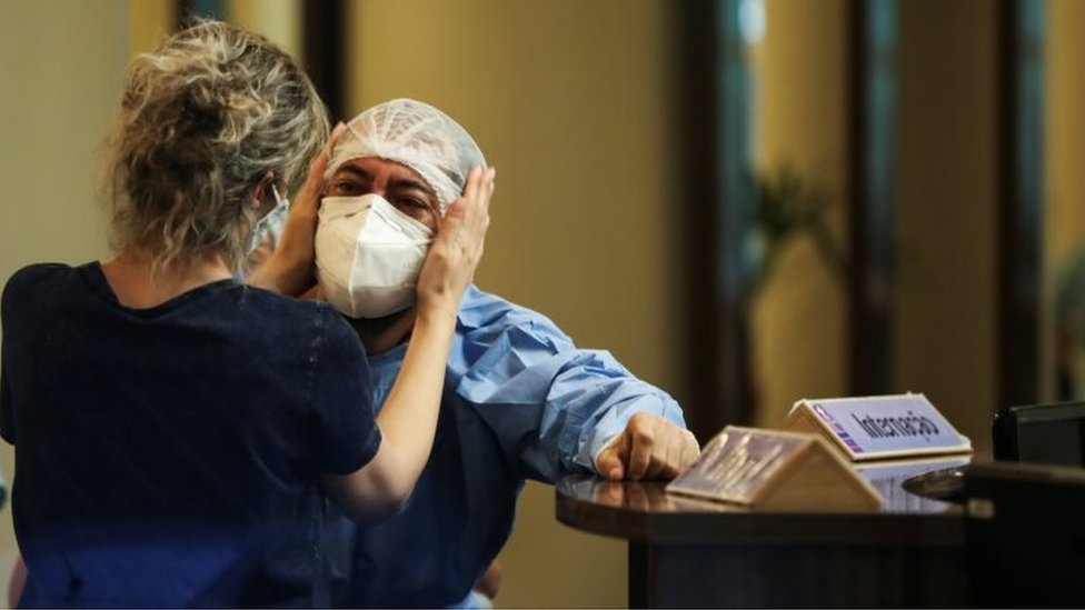 A health worker reacts at Getulio Vargas hospital, amid the coronavirus disease