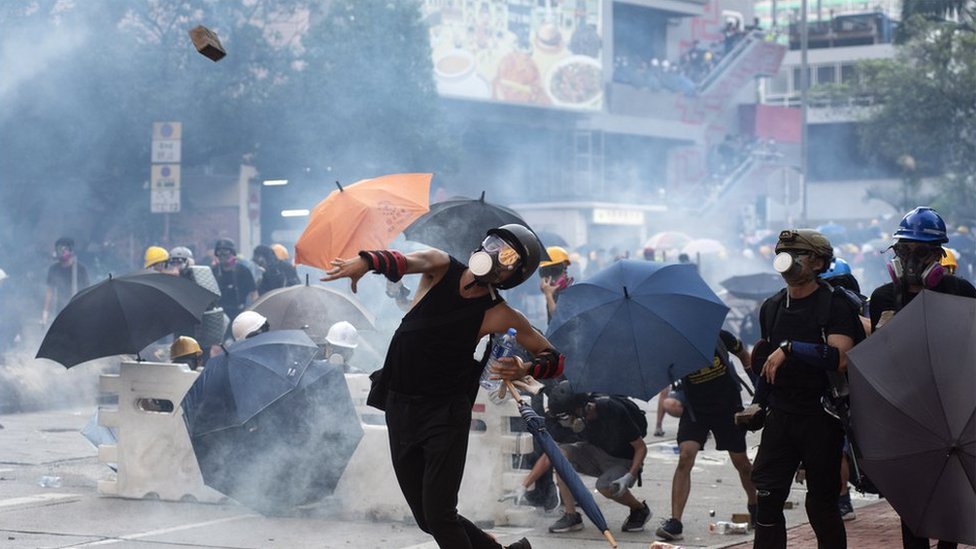 Protester throwing brick