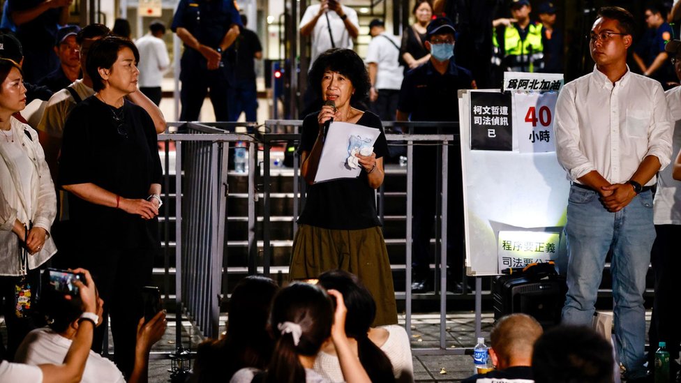 Chen Pei-chi (C), wife of former Taipei city mayor Ko Wen-je, addresses Ko's supporters outside Taipei city District Court, in Taipei, Taiwan, 31 August 2024.