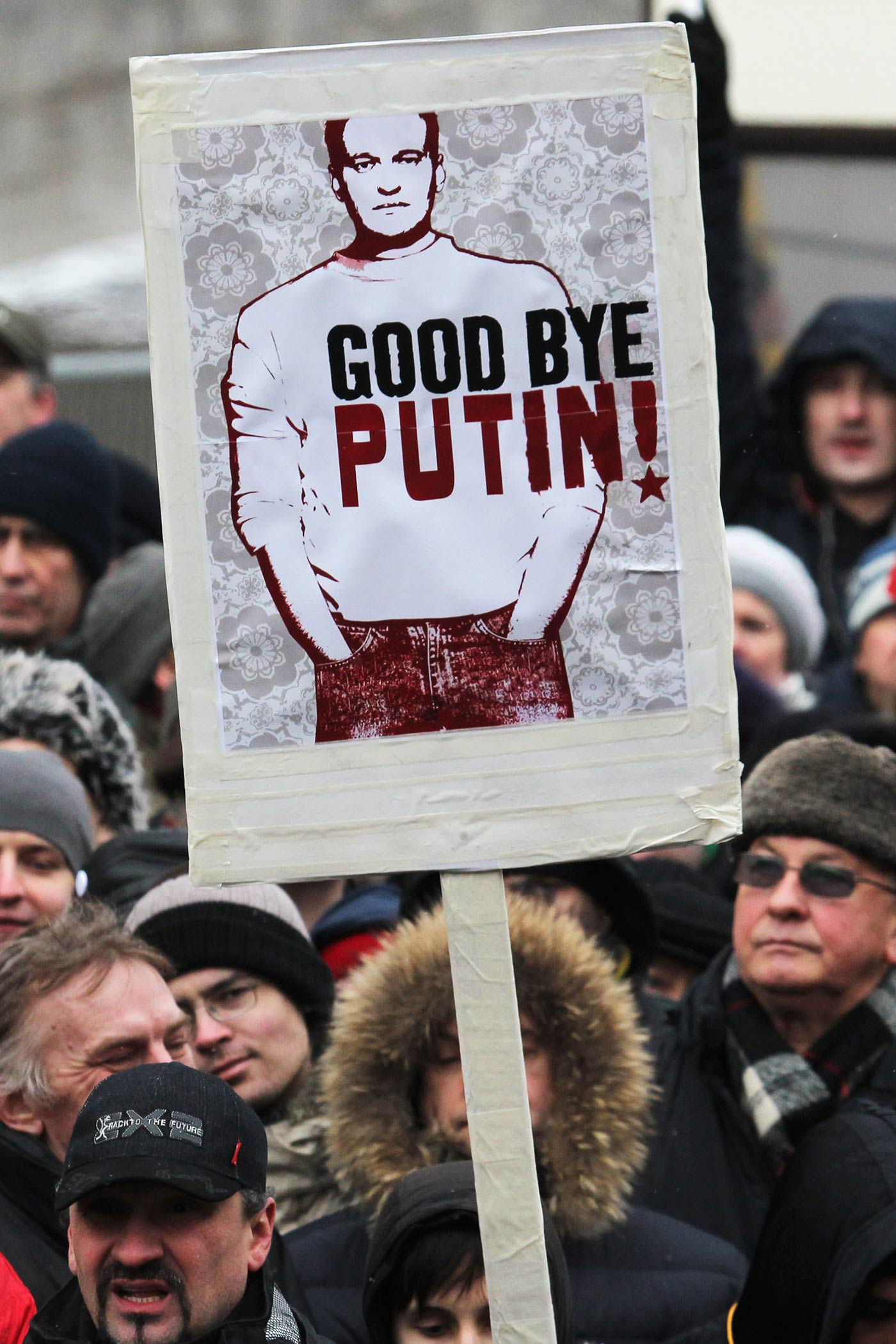 A demonstrator holds a sign with a portrait of Alexey Navalny during a mass anti-Putin rally in Moscow - 24 December 2011 