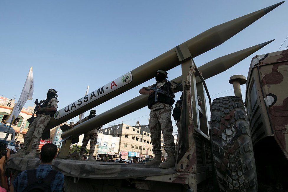 Palestinian militants from Hamas's military wing, the Izzedine al-Qassam Brigades, display a Qassam rocket at a parade in Rafah, southern Gaza, on 21 August 2016