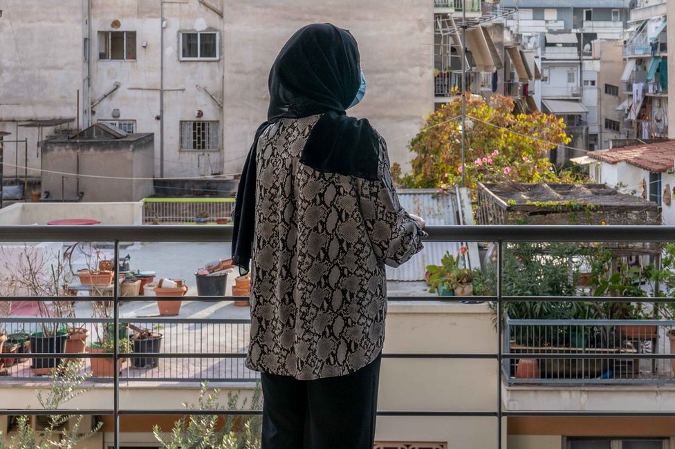 Recently arrived in Greece, Nargis looks out across the city