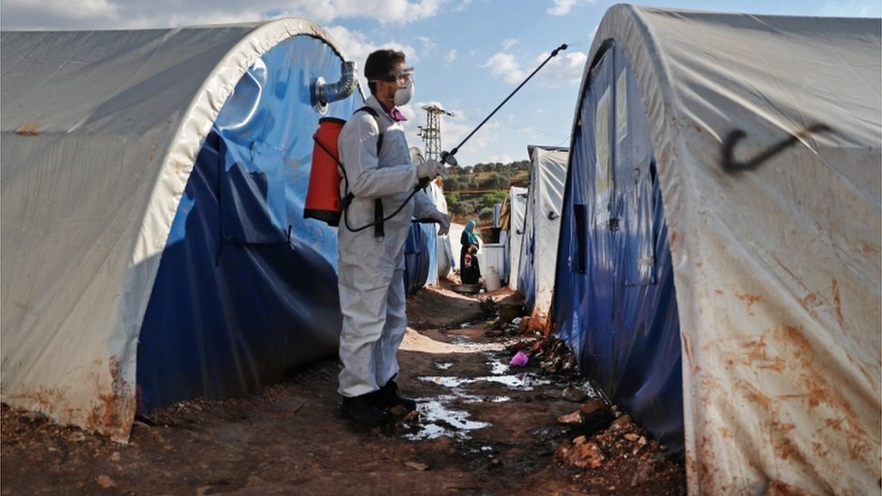 Член неправительственной организации Syrian Violet дезинфицирует палатки в лагере для перемещенных лиц в деревне Кафр-Джалис, к северу от города Идлиб, 21 марта 2020 г.