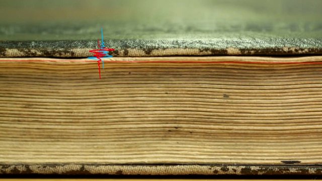 A closed book with a graphic of radiation waves superimposed on it