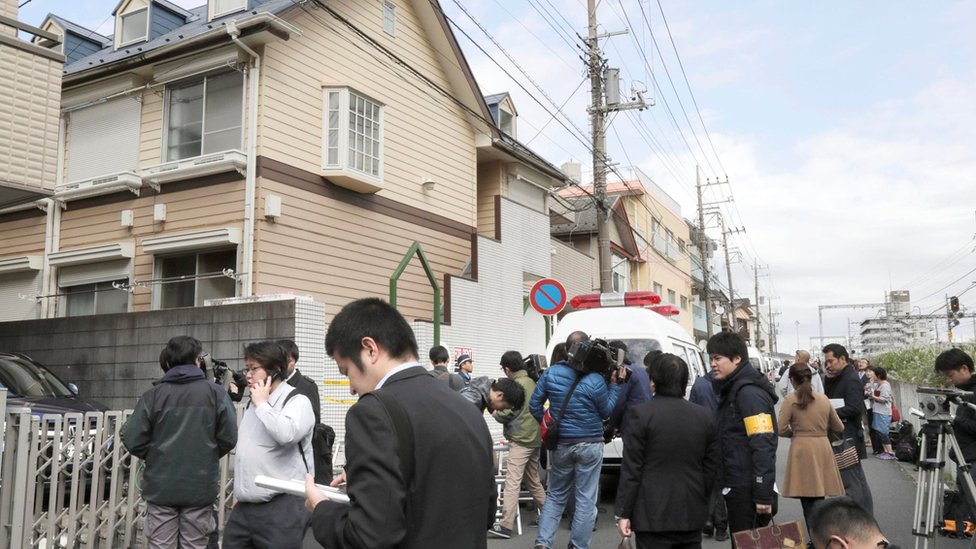 Members of the media gather in front of an apartment building where media reported nine bodies were found in Zama, Kanagawa Prefecture, Japan in this photo taken by Kyodo on October 31, 2017