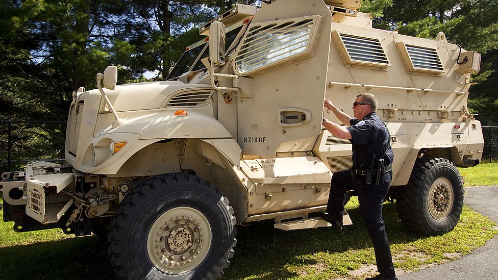 A police officer in Maine steps into a mine resistant ambush protected vehicle