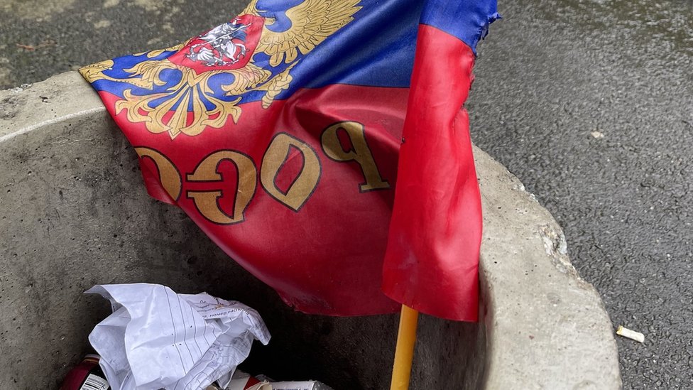 A Russian flag in a bin in Izyum