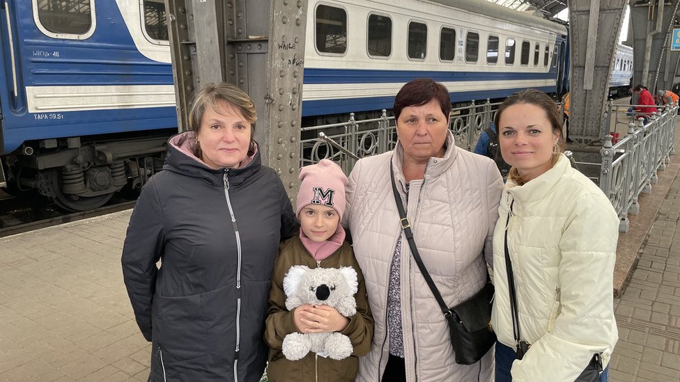 A family at Lviv's train station heading east