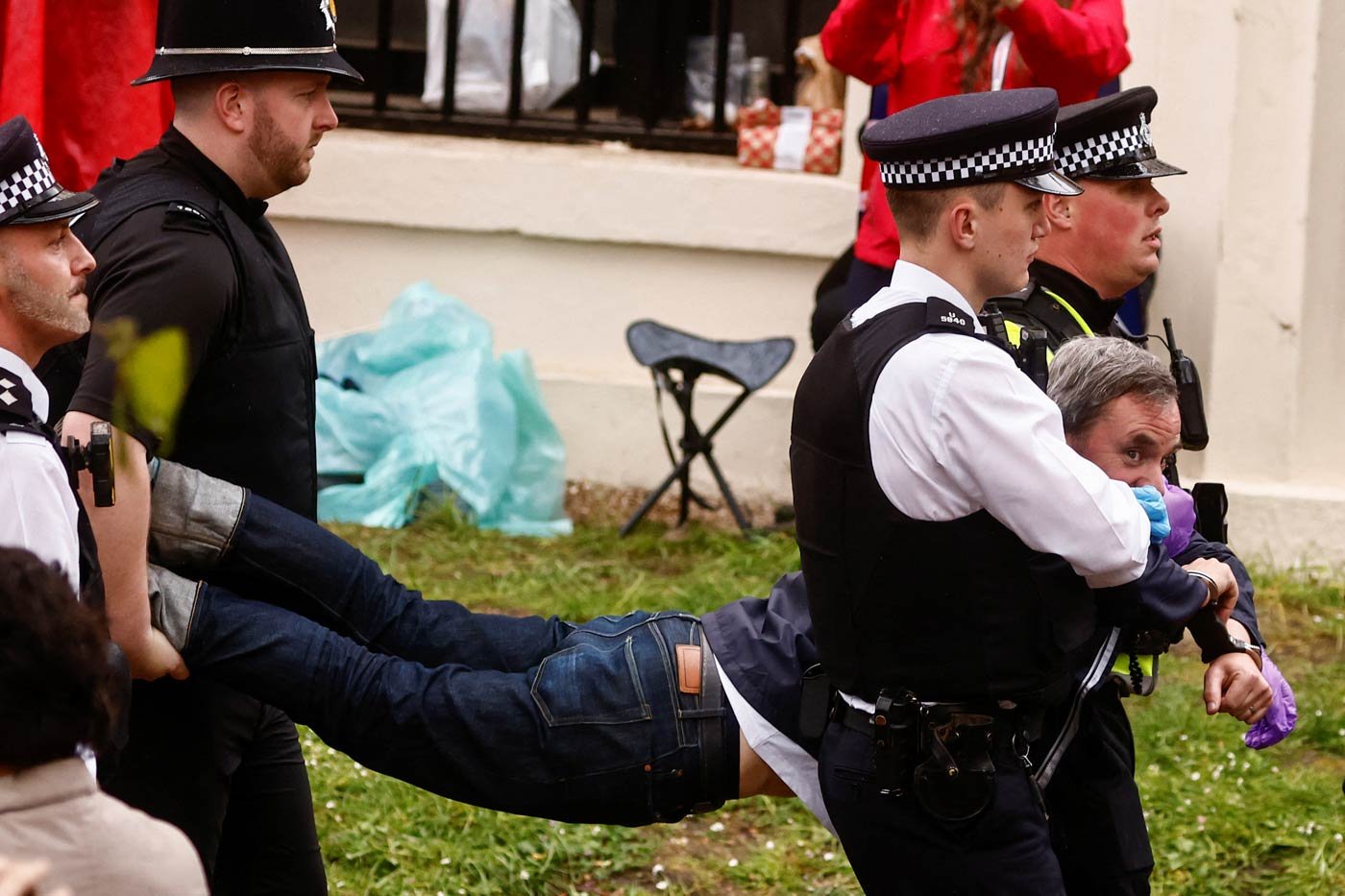 Police officers detain a member of "Just Stop Oil" movement during a protest ahead of the coronation ceremony
