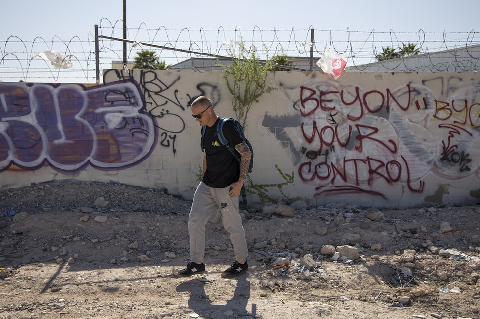 Robert Banghart camina junto a una pared con unos grafitis en una zona con gente sin techo al oeste del Strip en Las Vegas, Nevada, Estados Unidos, el 9 de abril de 2023.