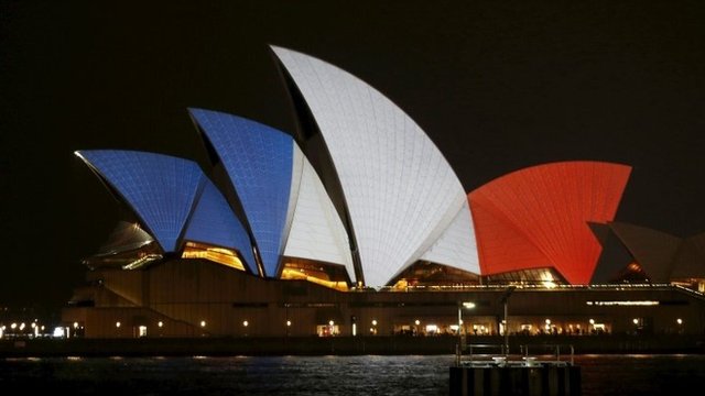 The blue, white and red colours of France's national flag are projected onto the sails of Sydney's Opera House in Australia, 14 November 2015