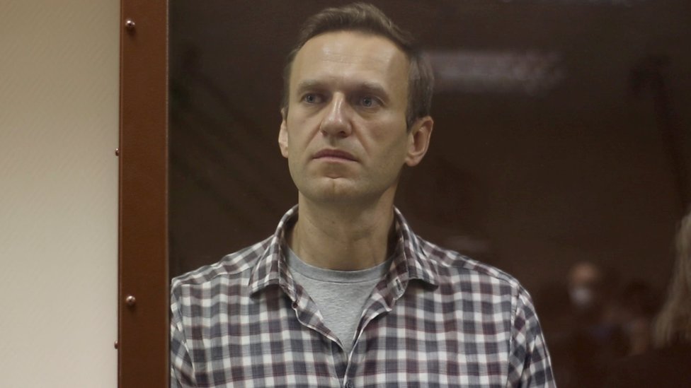 Kremlin critic Alexei Navalny stands inside a defendant dock during a court hearing in Moscow on 20 February