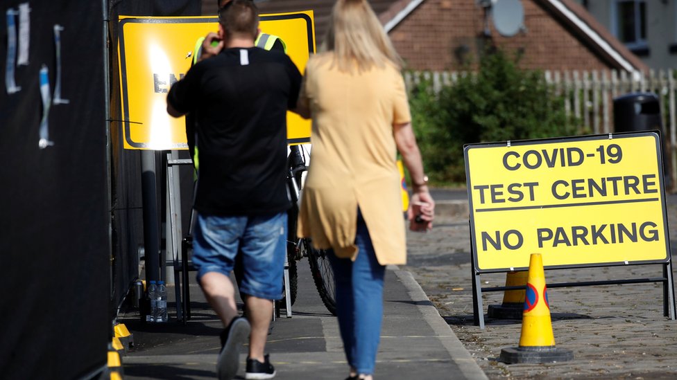 People arrive at a walk-in test facility following the outbreak of the coronavirus disease (COVID-19) in the Farnworth area of Bolton