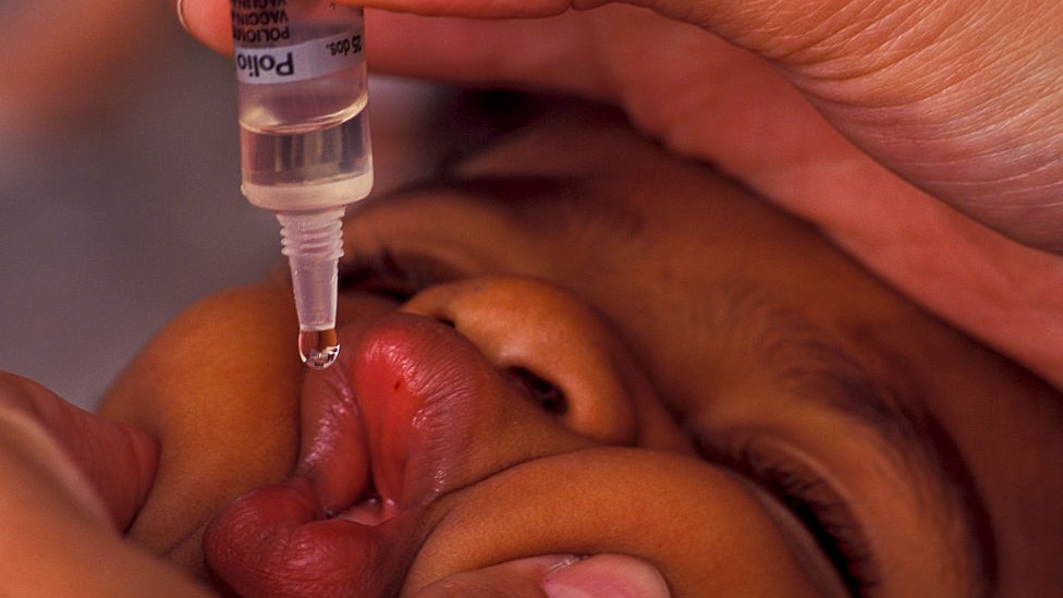 A child takes vaccine against poliomyelitis in a Brazilian clinic