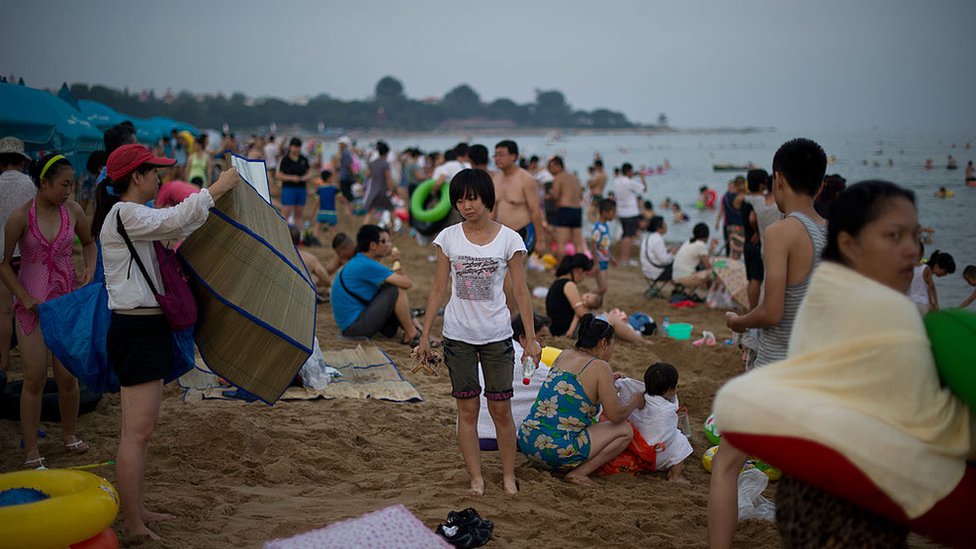 Turistas chinos disfrutando de una playa en Beidaihe.