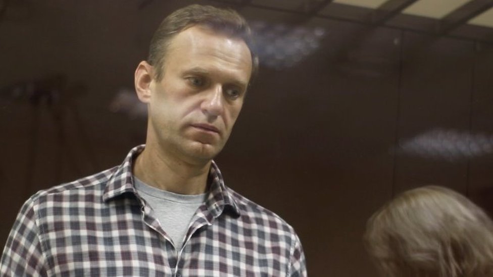 Kremlin critic Alexei Navalny stands inside a defendant dock during a court hearing in Moscow, Russia, on 20 February 2021,