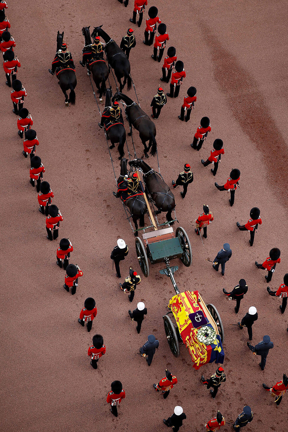 The coffin on an open gun carriage of the King's Troop Royal Horse Artillery, drawn by a team of black horses