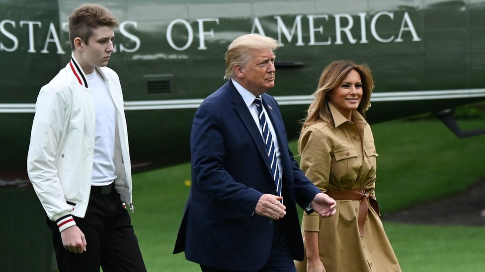 US President Donald Trump, First Lady Melania and their son Barron walk to the White House from Marine One in Washington, 16 August, 2020.