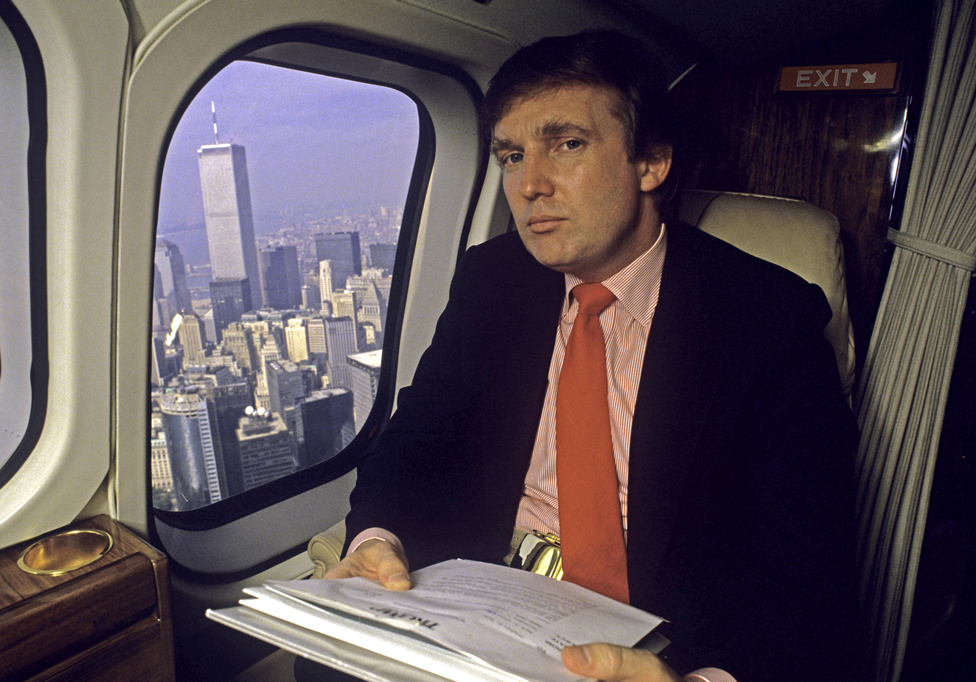 Donald Trump in his helicopter with the New York skyline below him