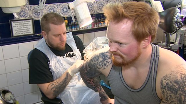 Man being tattooed