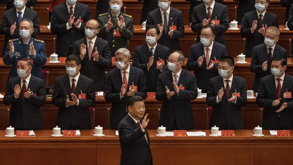 Chinese President Xi Jinping, right, is applauded as he waves to senior members of the government as he arrives to the Opening Ceremony of the 20th National Congress of the Communist Party of China at The Great Hall of People on October 16, 2022 in Beijing, China.