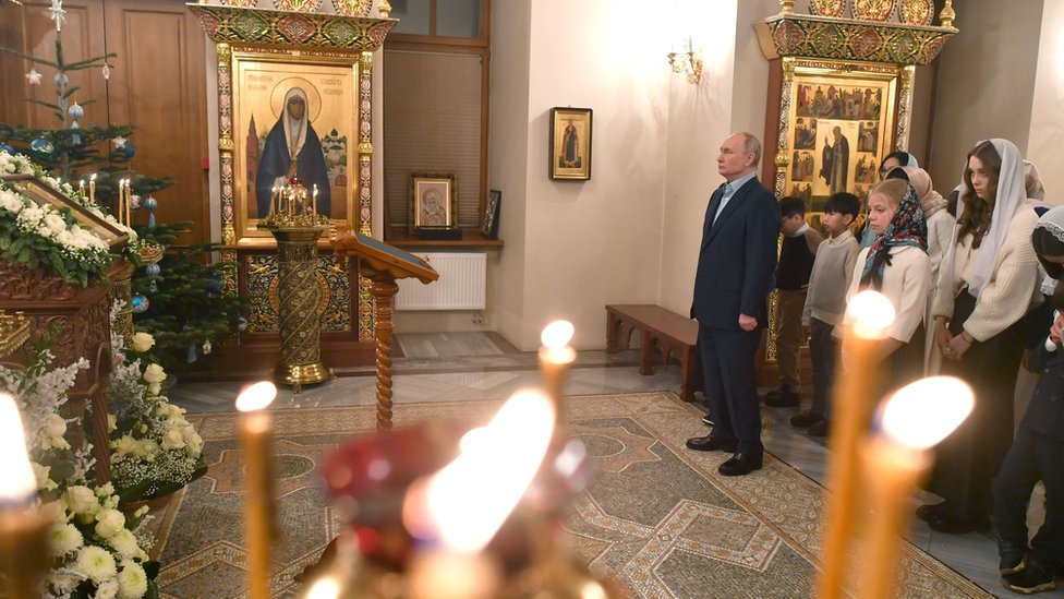 Russian president Vladimir Putin standing in an Orthodox Christian church during Christmas celebrations