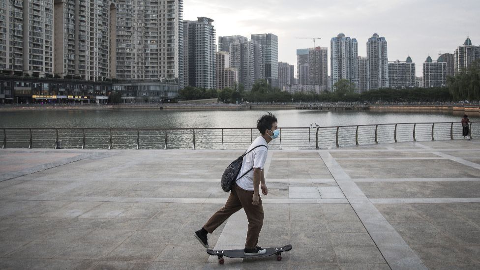 A man wears a mask plays skateboarding in Xibei lake park on May 11, 2020 in Wuhan, China.