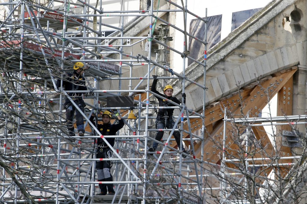 Workers are seen restoring the Notre-Dame cathedral