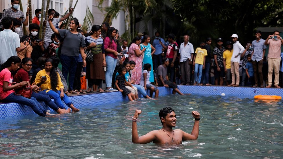 Un hombre en la piscina de la casa presidencial un día después de que los manifestantes ingresaran al edificio.
