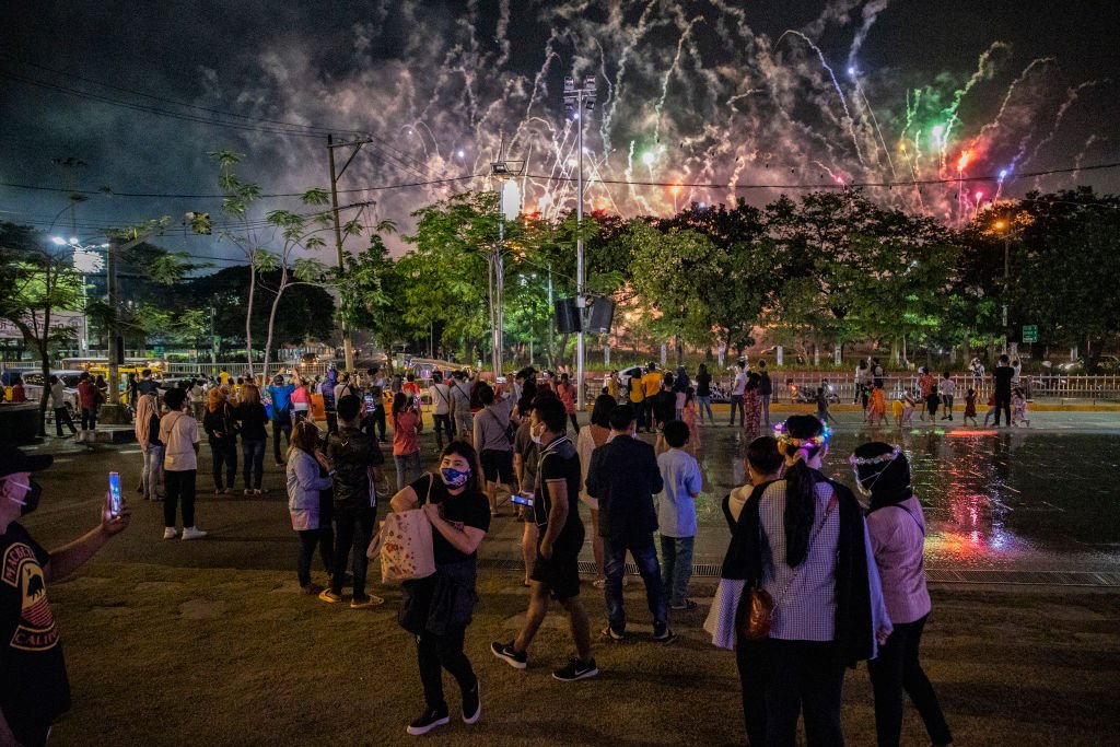 People gather in Manila to watch a fireworks display from a park