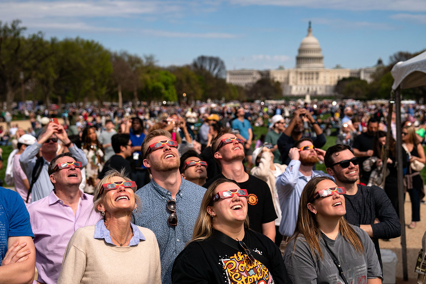 People gather on the National Mall to view the partial solar eclipse in Washington DC - 8 April 2024 (Kent Nishimura/Getty Images)