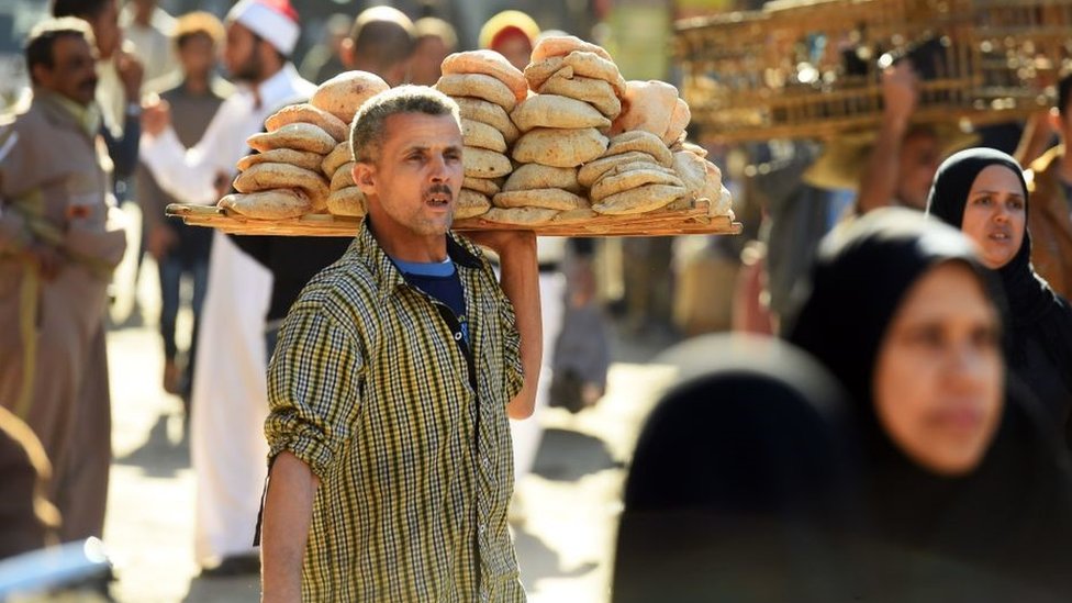 An Egyptian man sells bread outside the al-Azhar mosque in Cairo on December 8, 2017