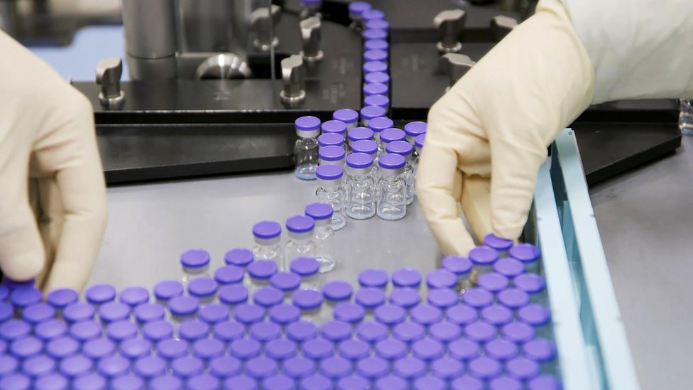 Vials of coronavirus disease (COVID-19) vaccine candidate BNT162b2 are sorted at a Pfizer facility in Puurs, Belgium in an undated still image from video.
