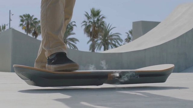 A man stepping on to a hoverboard