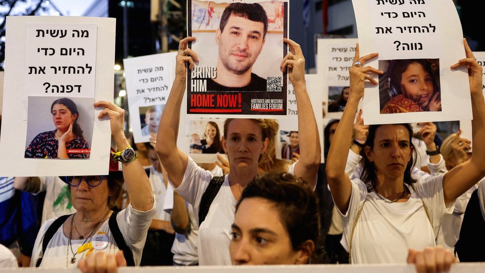 Protesters in Tel Aviv, Israel, hold signs demanding the release of hostages being held by Hamas in Gaza (21 November 2023)