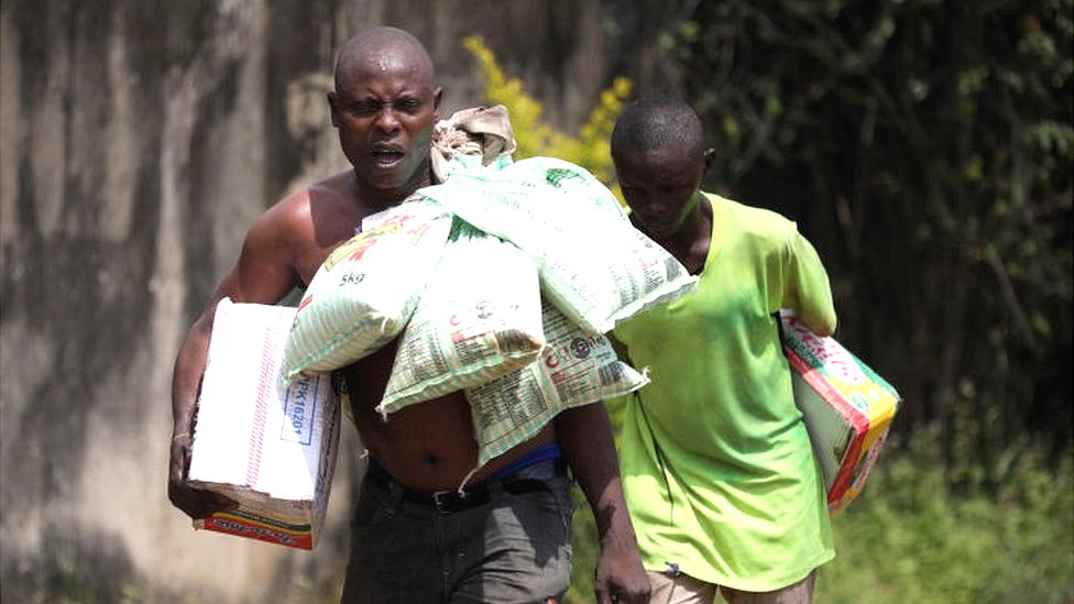 A man carrying bags of rice