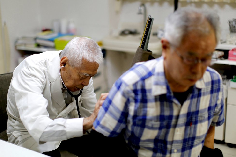 Ryuichi Nagayama examines a patient