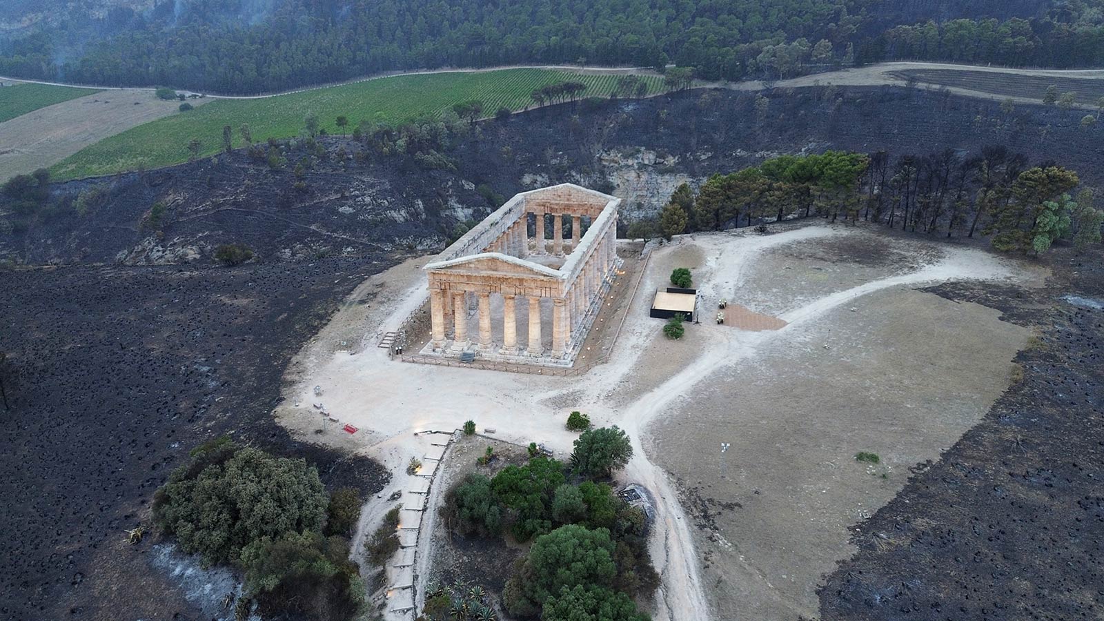 ​​Burnt vegetation is seen around the ancient temple of Segesta which has been threatened by a wildfire in the Sicilian Archaeological Park of Segesta, Italy - 25 July 2023