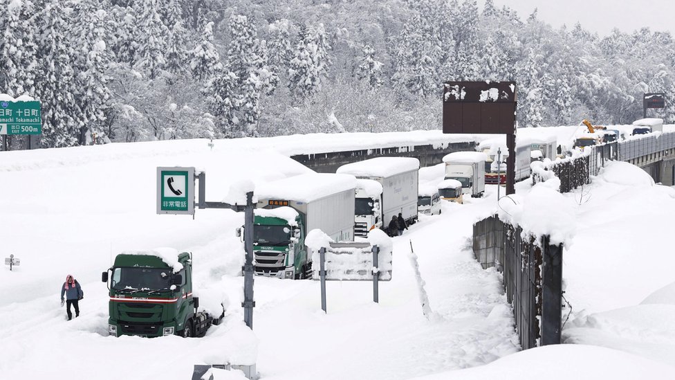 Vehicles are stranded on the snow-covered Kanetsu expressway in Minamiuonuma in Niigata Prefecture,