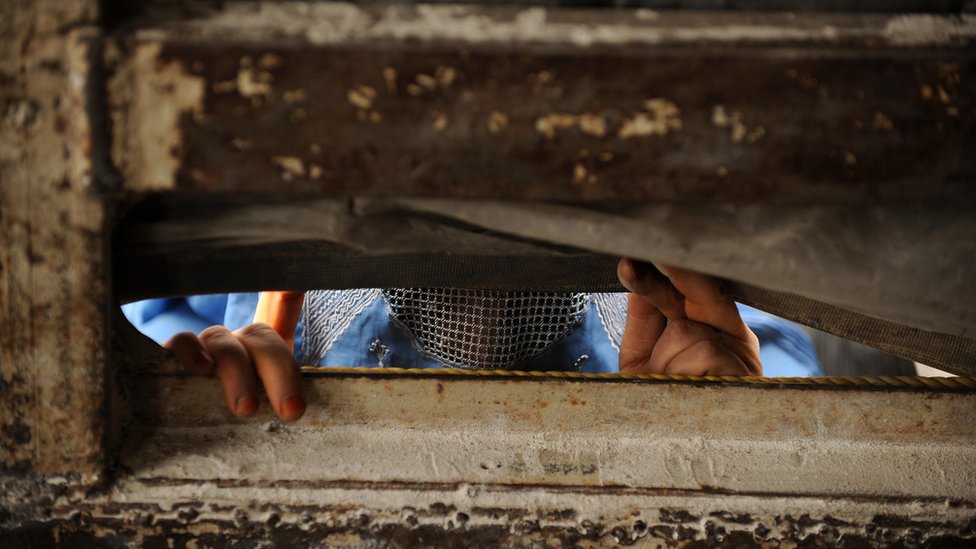 A displaced Afghan woman asks for donations in the outskirts of Kabul on September 1, 2009.