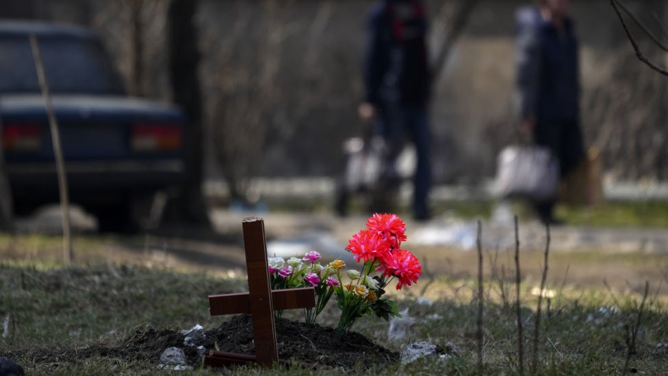 Flowers placed on a grave in Mariupol